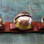 Laced strap with 23 graduated bells